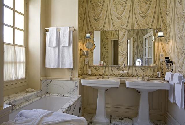 Luxury French bathroom decor. Beautiful Avignon Hotel La Mirande on Hello Lovely Studio.